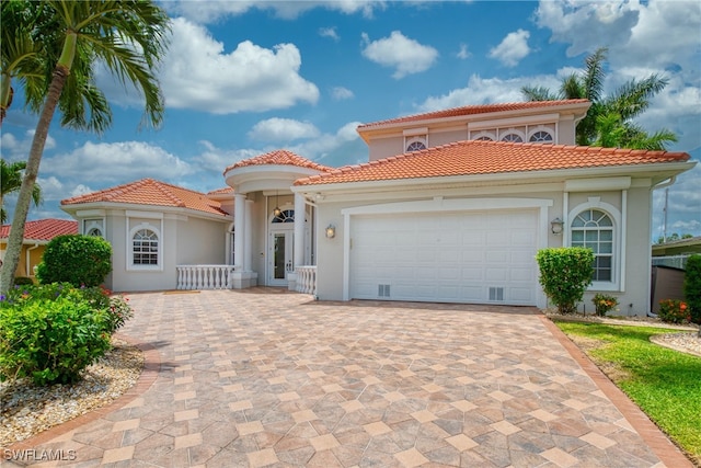 mediterranean / spanish house with a garage