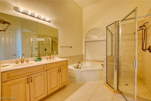 bathroom featuring tile patterned flooring, shower with separate bathtub, and vanity