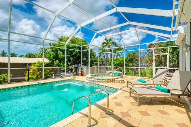 view of swimming pool featuring a patio, glass enclosure, and an in ground hot tub