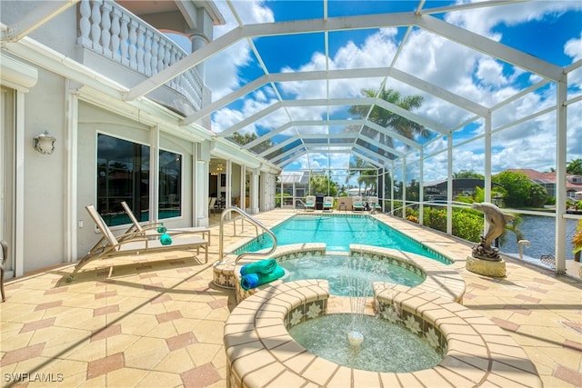 view of swimming pool with a lanai, an in ground hot tub, and a patio area