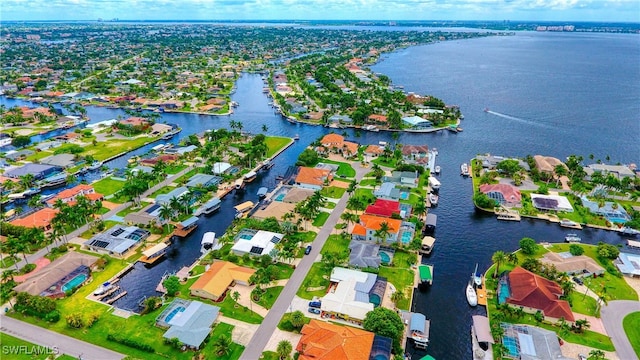 birds eye view of property with a water view