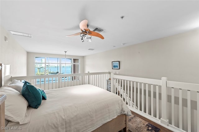 bedroom with ceiling fan and hardwood / wood-style floors