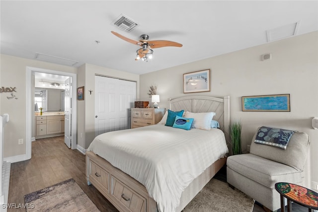 bedroom featuring a closet, hardwood / wood-style floors, ensuite bath, and ceiling fan