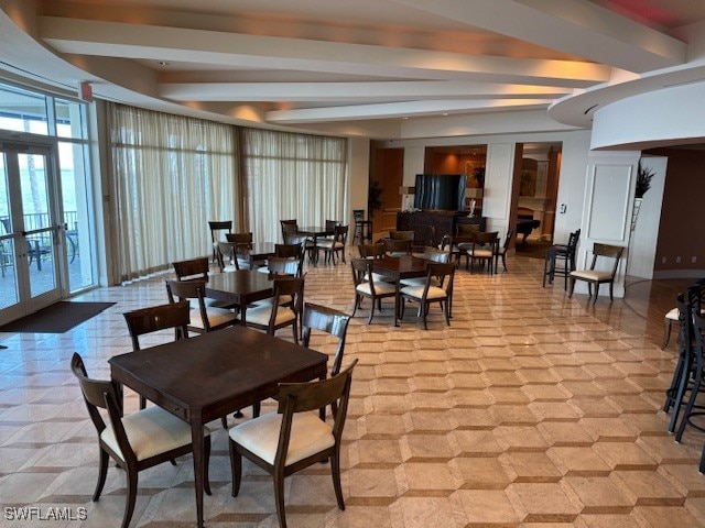 dining room featuring french doors and beam ceiling