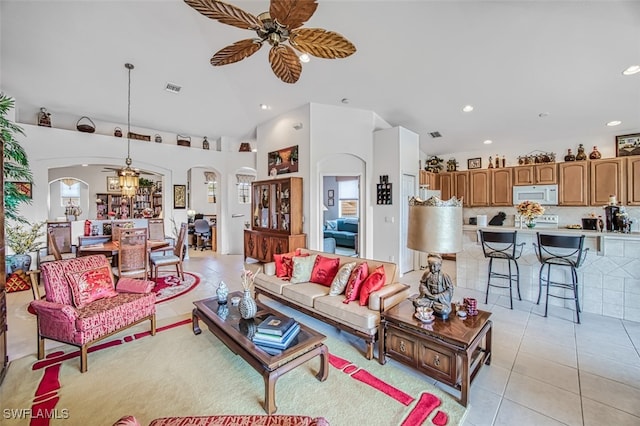 tiled living room featuring ceiling fan and lofted ceiling