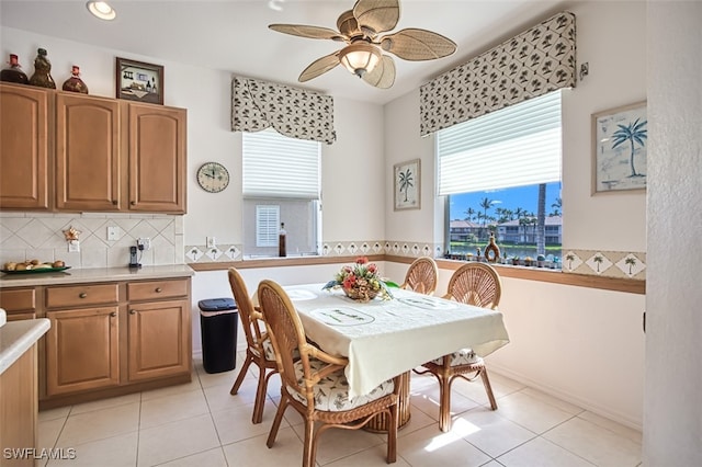 tiled dining area with ceiling fan