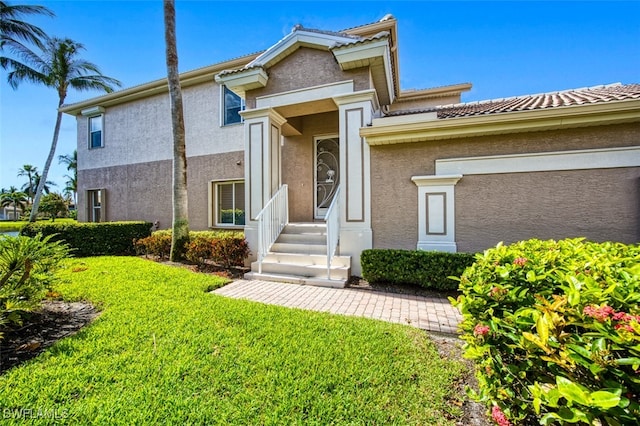 7831 Reflecting Pond Ct Unit 1821, Fort Myers, FL 33907 - view of front facade with a tile roof, a front yard, and stucco siding