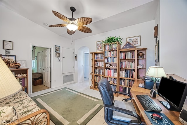 office featuring visible vents, arched walkways, light tile patterned floors, ceiling fan, and vaulted ceiling