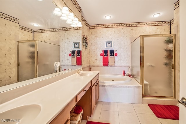 full bathroom with wallpapered walls, a whirlpool tub, double vanity, tile patterned floors, and a sink