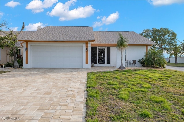 ranch-style home featuring a front yard and a garage