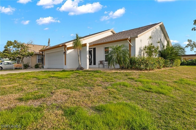 ranch-style home with a garage and a front lawn