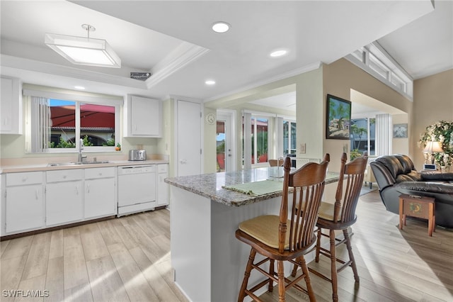 kitchen featuring white cabinets, light wood-type flooring, white dishwasher, and sink