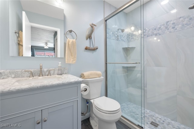 bathroom featuring toilet, vanity, and walk in shower