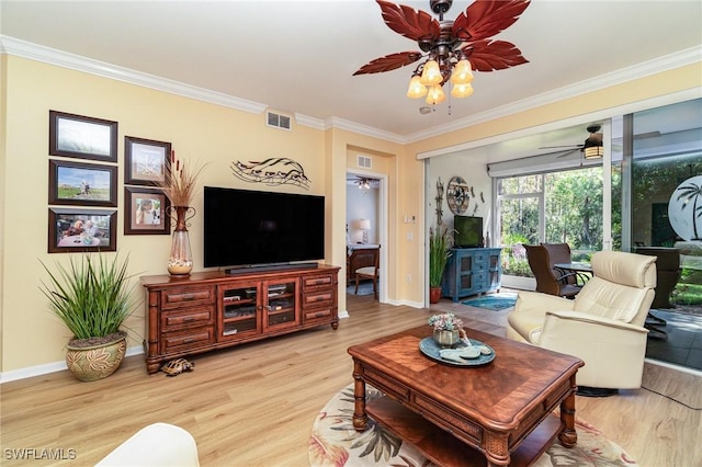 living room with light wood-type flooring and crown molding