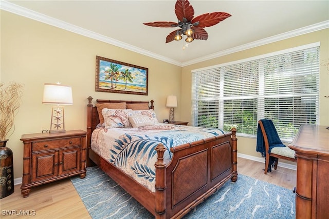 bedroom featuring light hardwood / wood-style flooring, ornamental molding, and ceiling fan