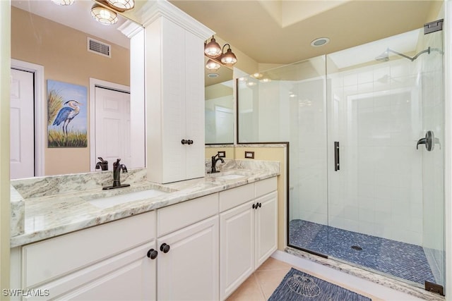 bathroom featuring vanity, tile patterned flooring, and a shower with shower door