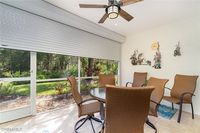 tiled dining area with ceiling fan