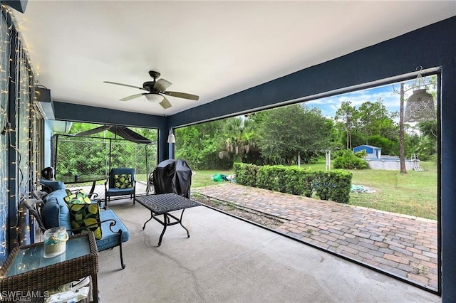 sunroom featuring ceiling fan