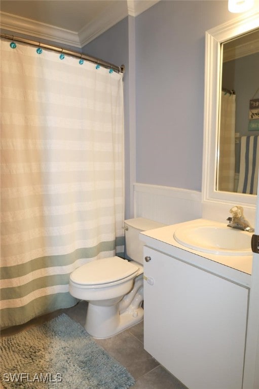 bathroom with tile patterned floors, ornamental molding, toilet, and vanity