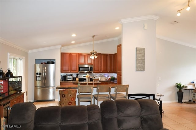 kitchen featuring light tile patterned flooring, decorative backsplash, ornamental molding, kitchen peninsula, and stainless steel appliances