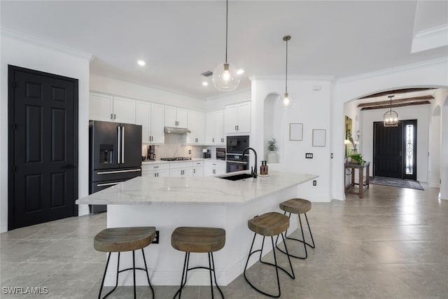 kitchen featuring a spacious island, sink, black appliances, and white cabinets