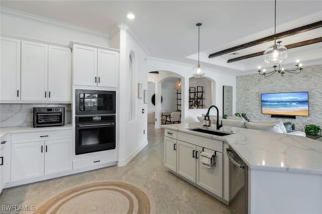 kitchen featuring white cabinetry, decorative light fixtures, black appliances, and sink