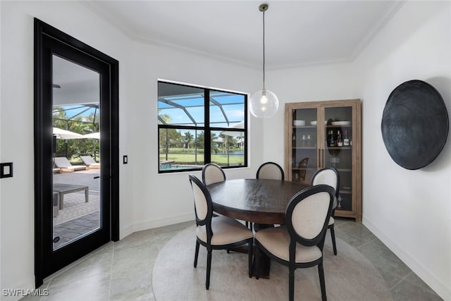 dining room with ornamental molding, light tile patterned floors, and plenty of natural light