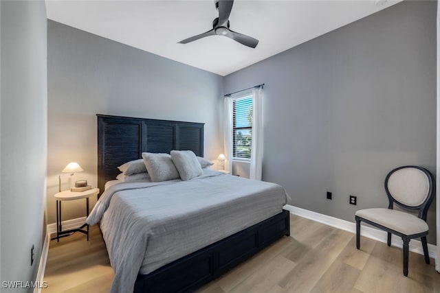 bedroom with light hardwood / wood-style flooring and ceiling fan