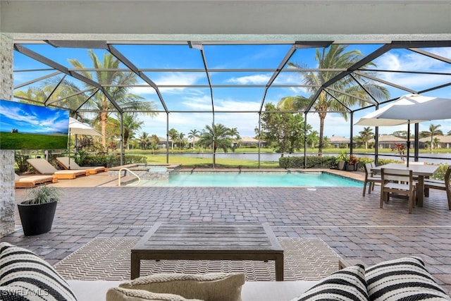 view of pool featuring a patio and glass enclosure