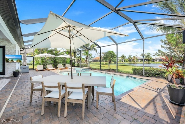 view of swimming pool with a patio, an in ground hot tub, a lanai, and a water view