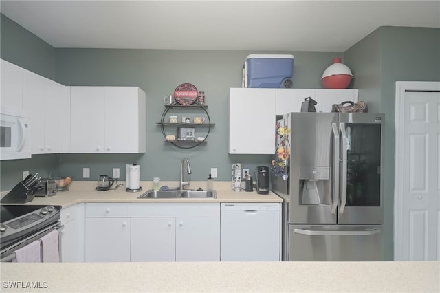 kitchen with white cabinetry, appliances with stainless steel finishes, and sink