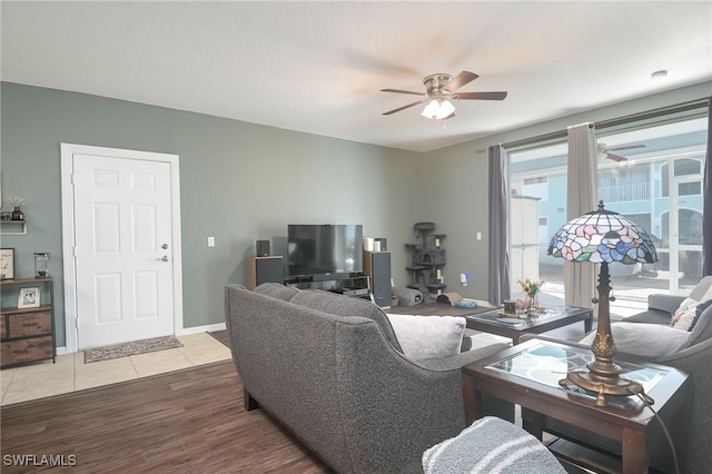 living room with light wood-type flooring and ceiling fan