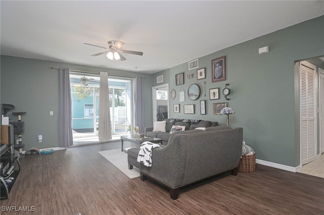 living room with ceiling fan and wood-type flooring