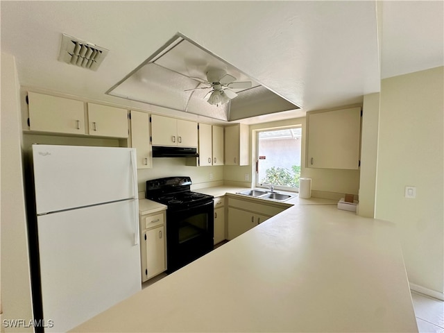 kitchen featuring cream cabinets, sink, black range with electric stovetop, white fridge, and ceiling fan