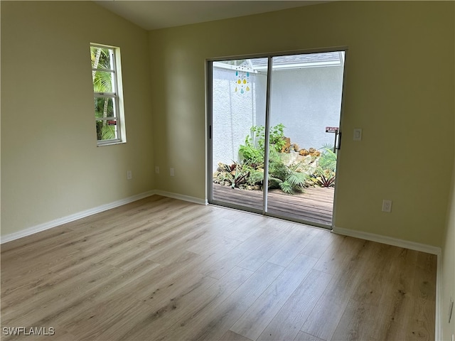 spare room with light hardwood / wood-style flooring