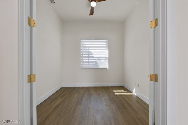 empty room featuring dark hardwood / wood-style floors and ceiling fan