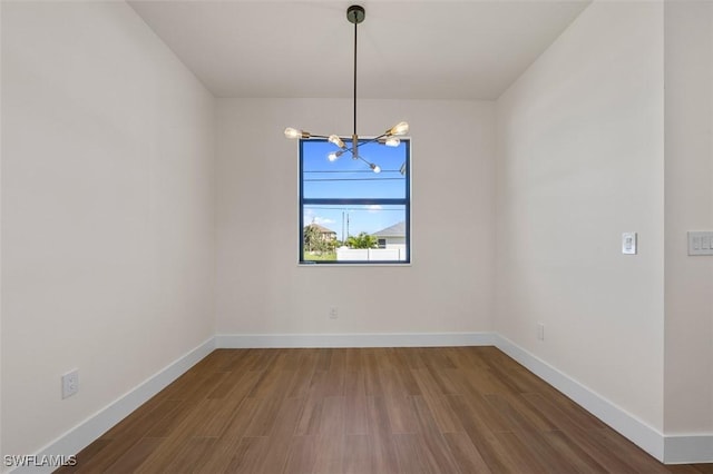 209 Kismet Pkwy E, Cape Coral, FL 33909 - spare room with an inviting chandelier, baseboards, and wood finished floors