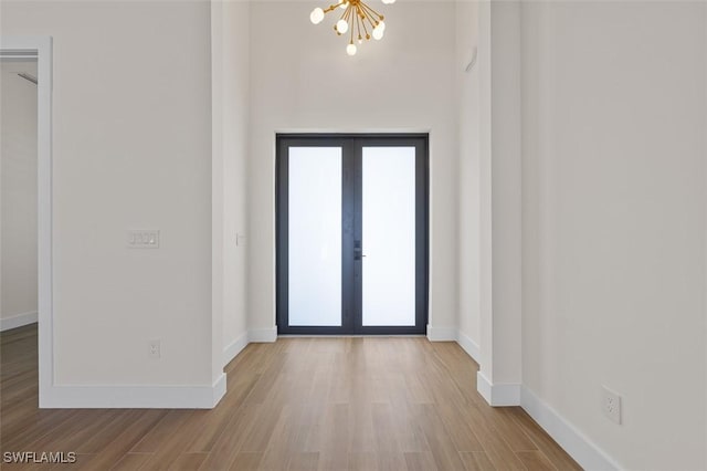 209 Kismet Pkwy E, Cape Coral, FL 33909 - interior space featuring baseboards, french doors, wood finished floors, and a notable chandelier