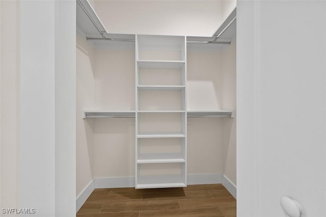 209 Kismet Pkwy E, Cape Coral, FL 33909 - walk in closet featuring wood finished floors
