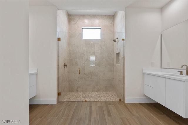 209 Kismet Pkwy E, Cape Coral, FL 33909 - bathroom featuring tiled shower, baseboards, vanity, and wood finished floors