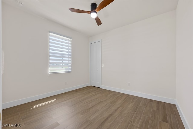 empty room with hardwood / wood-style floors and ceiling fan