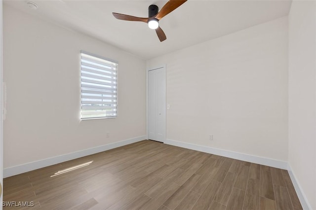 209 Kismet Pkwy E, Cape Coral, FL 33909 - unfurnished room with a ceiling fan, baseboards, and wood finished floors