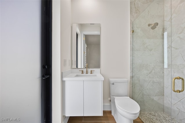 bathroom featuring vanity, toilet, and walk in shower