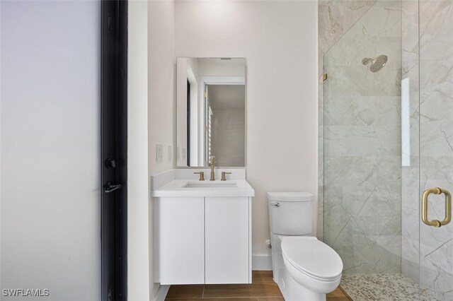 209 Kismet Pkwy E, Cape Coral, FL 33909 - bathroom featuring vanity, a marble finish shower, wood finished floors, and toilet