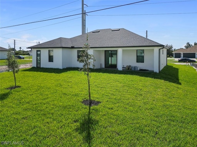 209 Kismet Pkwy E, Cape Coral, FL 33909 - rear view of house with stucco siding, a lawn, and roof with shingles