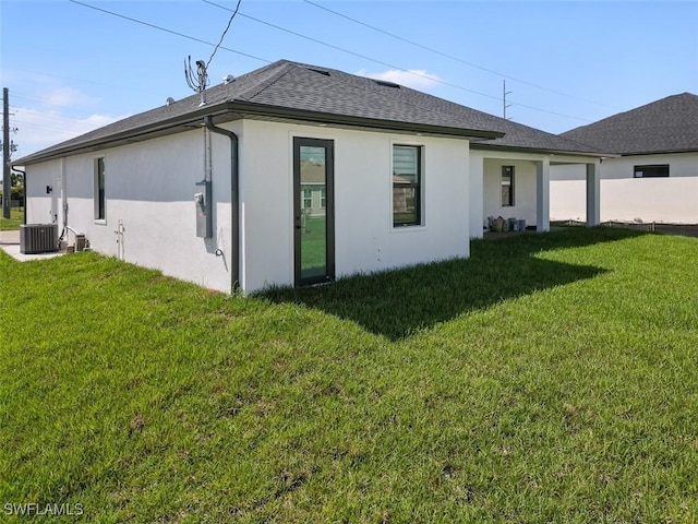 209 Kismet Pkwy E, Cape Coral, FL 33909 - rear view of house with stucco siding, a lawn, and a shingled roof