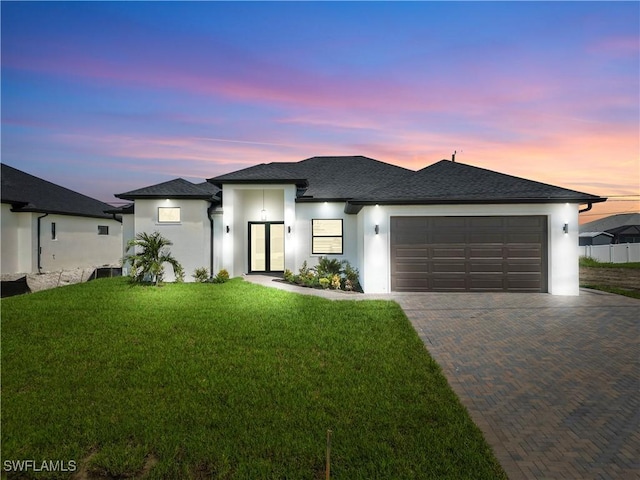209 Kismet Pkwy E, Cape Coral, FL 33909 - view of front facade featuring stucco siding, an attached garage, decorative driveway, a lawn, and french doors