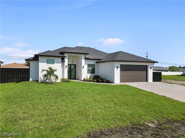 prairie-style house with a garage and a front lawn