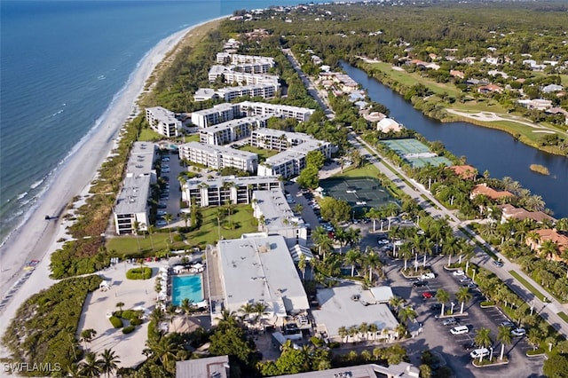 drone / aerial view featuring a water view and a view of the beach