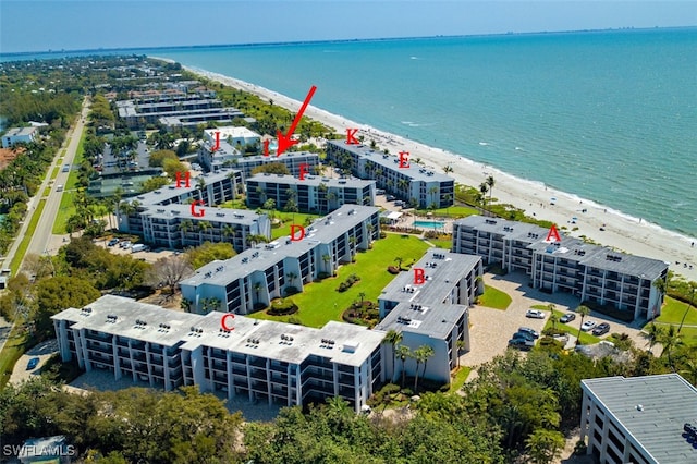 birds eye view of property with a beach view and a water view